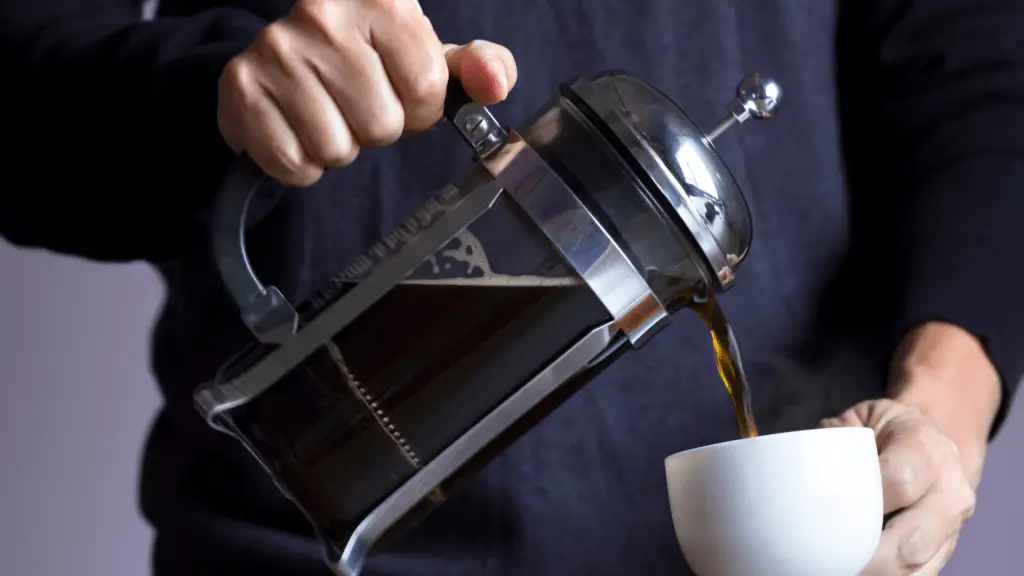 man pouring the best ground coffee for french press into a cup