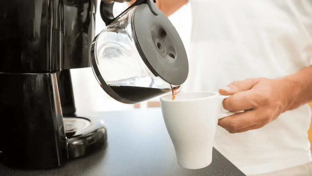 man pouring coffee that has been left to sit out